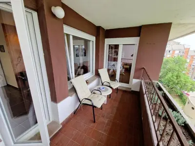 a balcony with two chairs and a table at Apartment Nena in Tošin Bunar