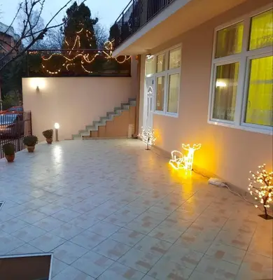 a patio with lights in front of a house at Nilena apartmani in Smederevo