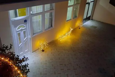 a hallway with lights in front of a door at Nilena apartmani in Smederevo
