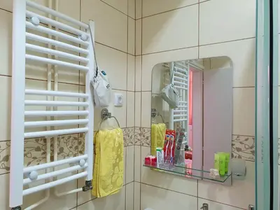 a bathroom with a mirror and a sink at Nilena apartmani in Smederevo