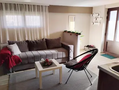 a living room with a couch and a chair at Apartman Talija in Arandjelovac