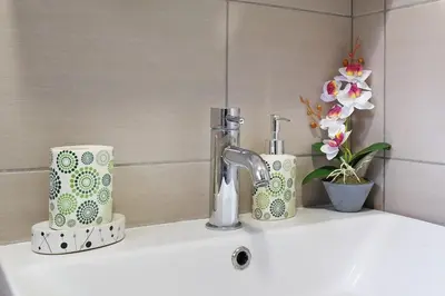 a sink with two cups and a faucet on it at Apartment Paradise Fantasy in Belgrade