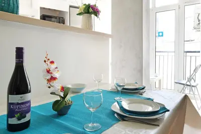 a bottle of wine sitting on a table with glasses at Apartment Paradise Fantasy in Belgrade