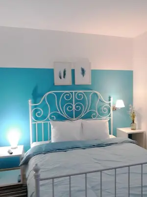 a blue bedroom with a bed with a blue headboard at BLUE DANUBE in Belgrade