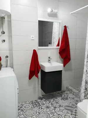 a white bathroom with a sink and a mirror at BLUE DANUBE in Belgrade