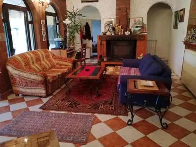 a living room with a couch and a table at Kuća na dan Villa Holiday in Sakule