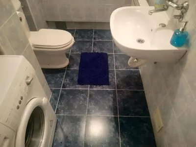 a bathroom with a toilet and a sink and a washing machine at Nika Apartment in Belgrade