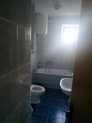 a bathroom with a tub and a toilet and a sink at Nika Apartment in Belgrade
