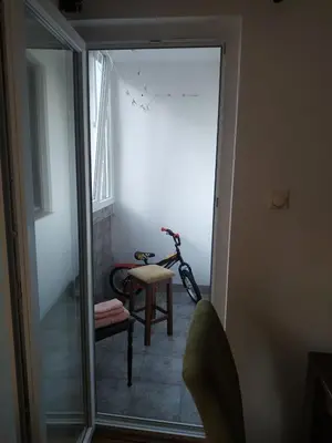 a room with a bike and a chair in a room at Nika Apartment in Belgrade