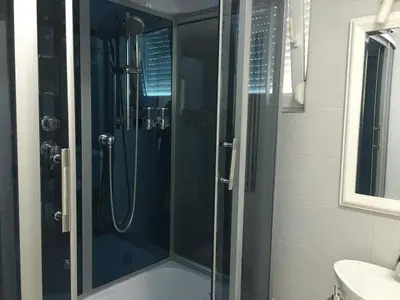 a shower with a glass door in a bathroom at Apartmani Spasić in Smederevo