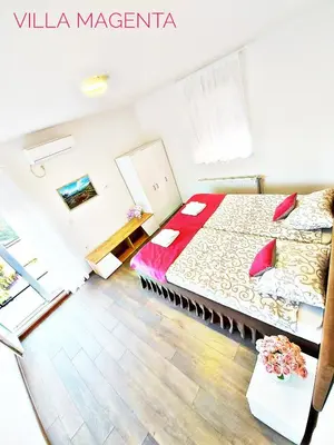 a small room with a bed and a table at MAGENTA Apartments in Belgrade