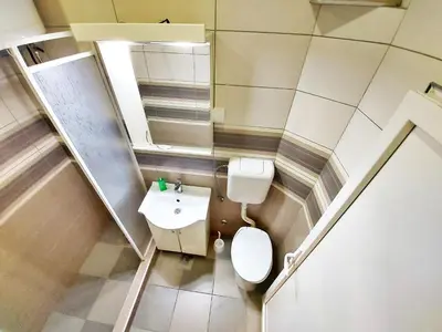 a bathroom with a toilet and a sink and a mirror at MAGENTA Apartments in Belgrade