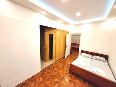 a bedroom with a bed and a wooden floor at MAGENTA Apartments in Belgrade