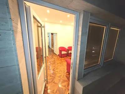 a view of a room with red chairs and a window at MAGENTA Apartments in Belgrade