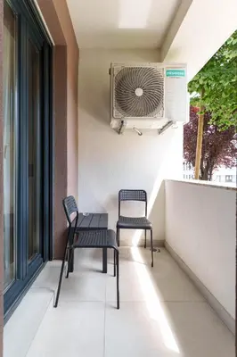 two chairs and a fan on a balcony at Zemunske Kapije in Belgrade