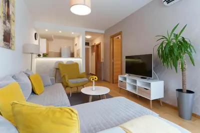 a living room with a couch and a tv at Zemunske Kapije in Belgrade