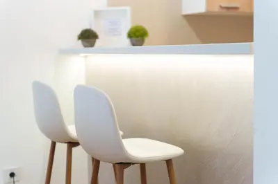 two white chairs sitting next to a counter at Zemunske Kapije in Belgrade