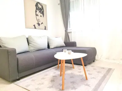 a living room with a couch and a table at Apartment Iskra in Belgrade