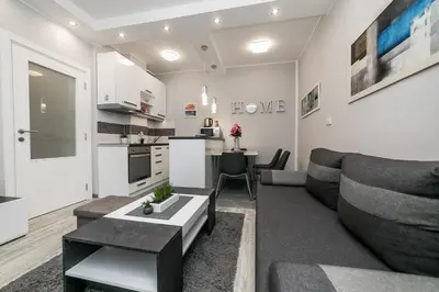 a living room with a couch and a table at Gray Luxe in Belgrade