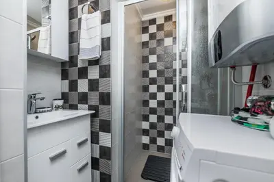 a small bathroom with a sink and a shower at Gray Luxe in Belgrade