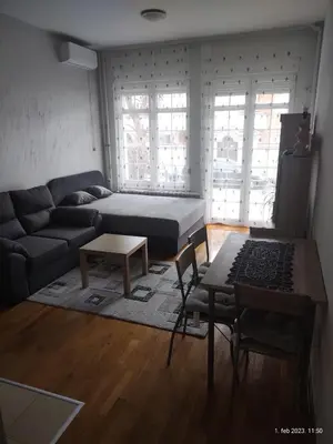 a living room with a bed and a couch at SUMICE apartment in Belgrade
