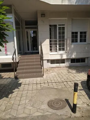 a house with a manhole in front of a building at SUMICE apartment in Belgrade