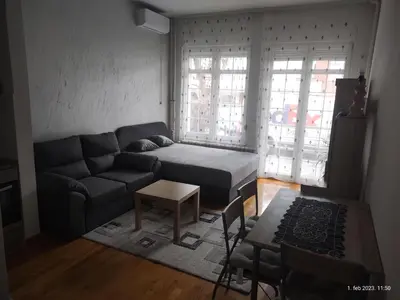 a living room with a couch and a table at SUMICE apartment in Belgrade