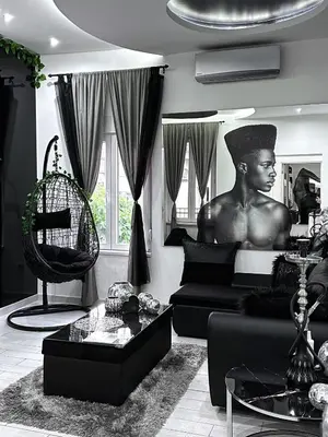a living room with a statue of a man on a bed at LUX apartment in downtown of Belgrade in Belgrade