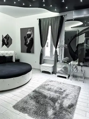 a black and white bedroom with a bed and a window at LUX apartment in downtown of Belgrade in Belgrade