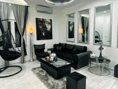 a living room with a black couch and a table at LUX apartment in downtown of Belgrade in Belgrade