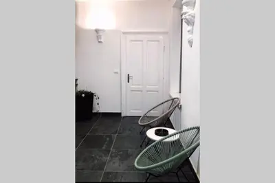 a room with two chairs and a table and a door at LUX apartment in downtown of Belgrade in Belgrade