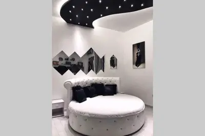 a bedroom with a white bed with black pillows at LUX apartment in downtown of Belgrade in Belgrade