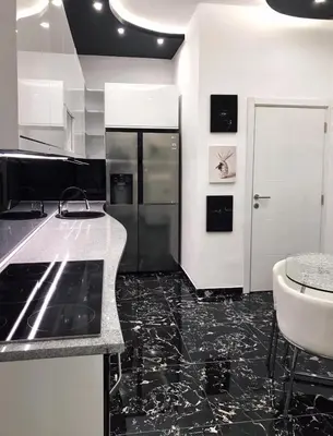 a black and white kitchen with a sink and a refrigerator at LUX apartment in downtown of Belgrade in Belgrade