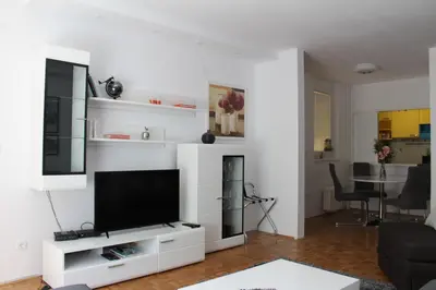 a living room with a tv on a white wall at Ramonda Residences - New Belgrade in Belgrade