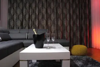 a living room with two wine glasses on a table at Ramonda Residences - New Belgrade in Belgrade