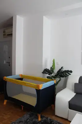 a ping pong table in a living room at Ramonda Residences - New Belgrade in Belgrade
