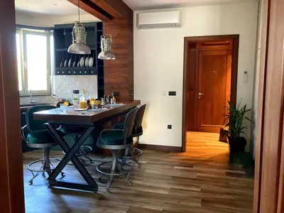 a kitchen with a table and chairs in a room at Apartman Lola in Vračar (historical)