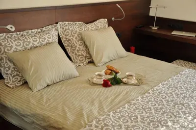 a bed with two towels and two stuffed animals on it at Apartman Lola in Vračar (historical)