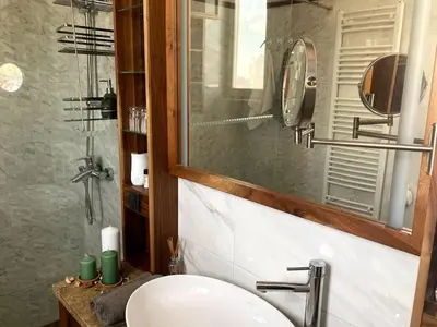 a bathroom with a sink and a mirror at Apartman Lola in Vračar (historical)