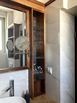 a bathroom with a sink and a mirror and a shower at Apartman Lola in Vračar (historical)