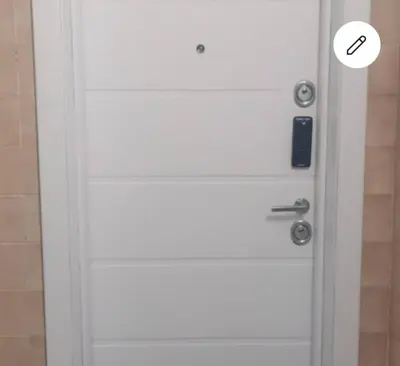 a white door with a sticker on it at High White Apartments in Belgrade