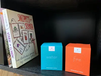 three books sitting on a shelf next to each other at Dragonfly Residence in Belgrade
