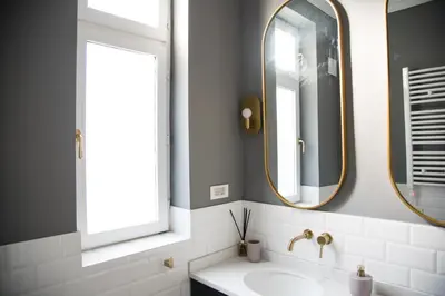 a bathroom with a sink and two mirrors at Dragonfly Residence in Belgrade