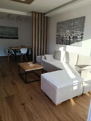 a living room with a couch and a table at Serbian home, Gandijeva 162, free parking in Belgrade