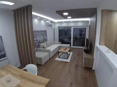 a living room with a couch and a table at Serbian home, Gandijeva 162, free parking in Belgrade