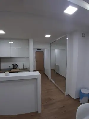 an empty room with a kitchen and a hallway at Serbian home, Gandijeva 162, free parking in Belgrade