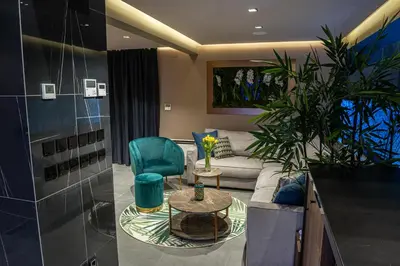 a living room with a couch and a table at Marconio Wellness Private Pool & SPA - City Center in Belgrade