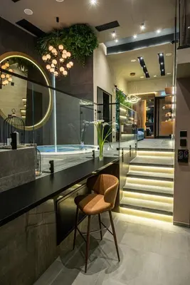 a bathroom with a chair and a sink at Marconio Wellness Private Pool & SPA - City Center in Belgrade