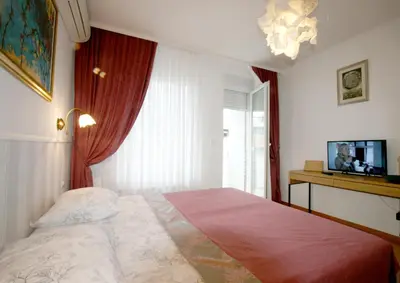 a bedroom with a large bed and a window at Apartment Moonstone 1 in Belgrade