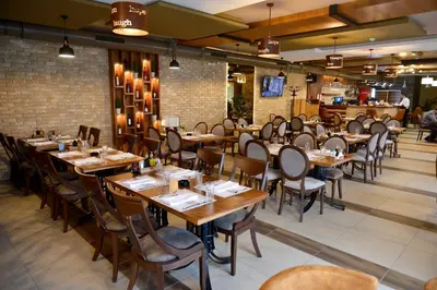 a dining room with wooden tables and chairs at MV Monogram in Inđija